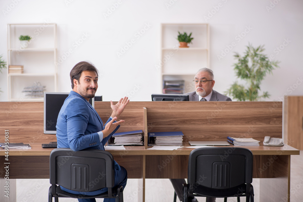 Two male employees working in the office Two male employees working in the office