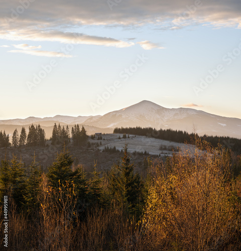 Picturesque sunrise above late autumn mountain countryside. Ukraine, Carpathian Mountains. Peaceful traveling, seasonal, nature and countryside beauty concept scene.