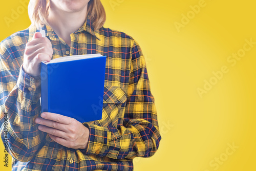 Woman in wool yellow and blue shirt on a yellow background