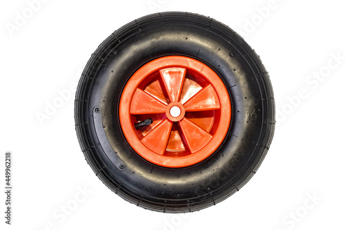 new nylon rubber inflatable black round wheel with red disc from garden wheelbarrow close up isolated on white background