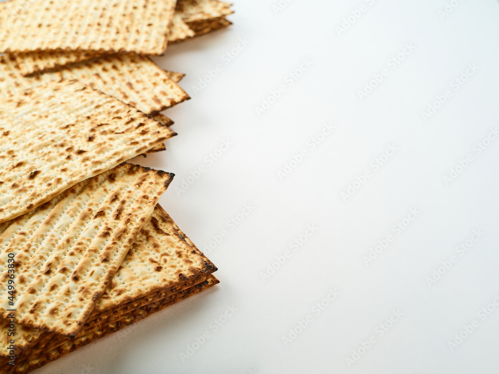 Matzakh is the sacred Jewish bread. Simple white background. High angle view. Jewish Passover, food, religion, traditions, synagogue, prayer. There is an empty space for insertion. Matzakh is the sacred Jewish bread. Simple white background. High angle view. Jewish Passover, food, religion, traditions, synagogue, prayer. There is an empty space for insertion.