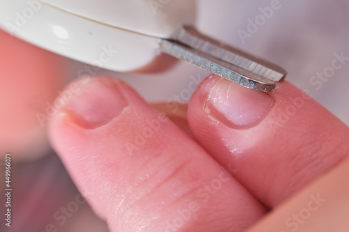 Cutting nails with special scissors on the fingers of a newborn baby  children manicure and cutting burrs