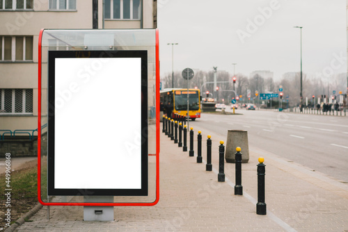 Blank billboard at bus stop for advertising with city's street on the background. Public transport. Transportation. Ad. Mock up. Mockup
