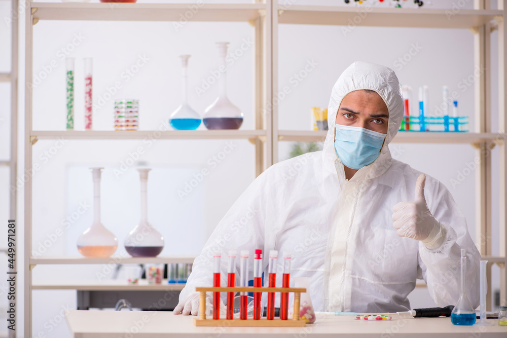 Young male chemist in drugs syntesis concept