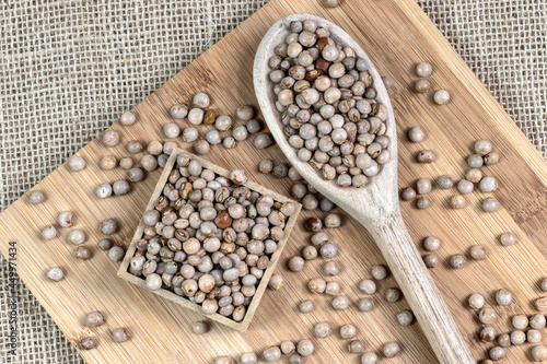 pigeon pea or tuvar beans or guandu bean (Cajanus cajan) seeds in transparent glass bowl and spoon on the wooden table in Brazil photo