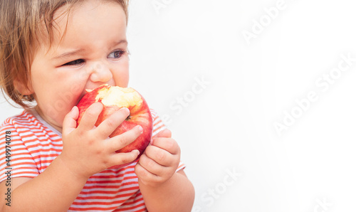 Child bites off apple