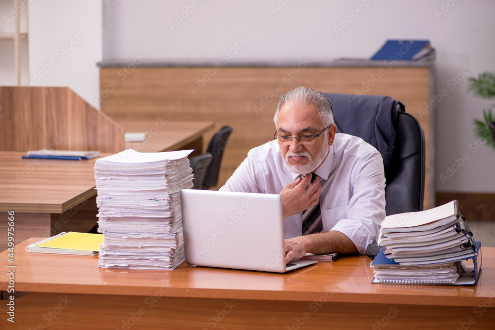 Old male employee and too much work in the office Old male employee and too much work in the office