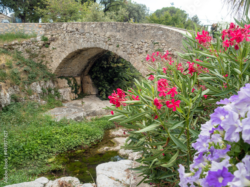 little Roman arch bridge in small provencal village in the French Riviera back country photo