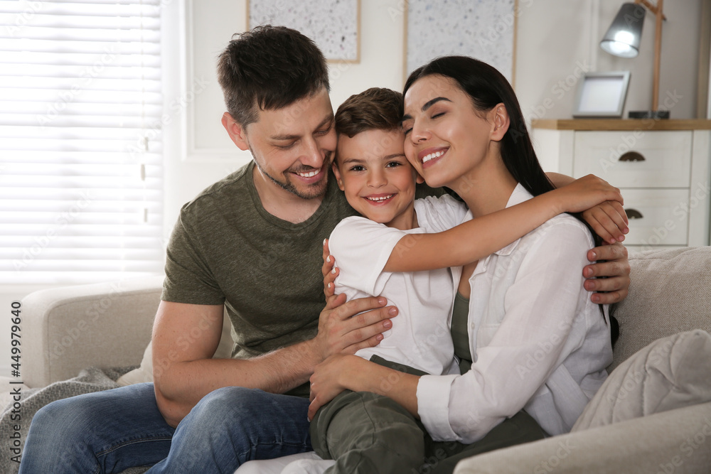 Happy family on sofa at home. Adoption concept Happy family on sofa at home. Adoption concept