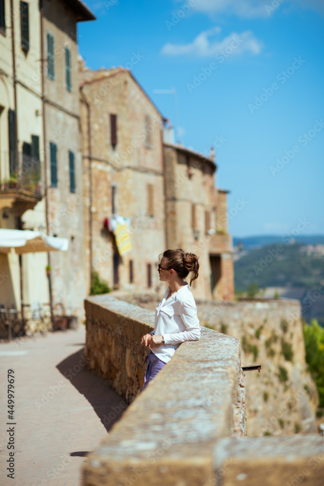 Seen from behind young solo traveller woman in Tuscany, Italy Seen from behind young solo traveller woman in Tuscany, Italy
