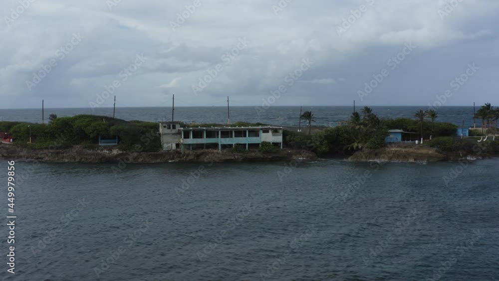 Low-level aerial view of Isla de Cabra in Puerto Rico a former Leper colony and military fortification. Now a tourist leisure park Low-level aerial view of Isla de Cabra in Puerto Rico a former Leper colony and military fortification. Now a tourist leisure park