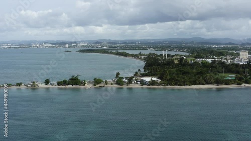 Push in aerial flight along the coast line of Isla de Cabra, Puerto Rico. photo