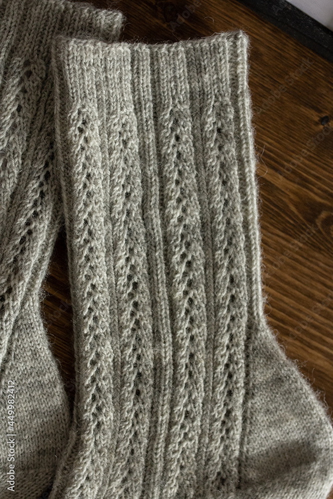Fototapeta premium Dark gray knitted men socks close up, woolen texture