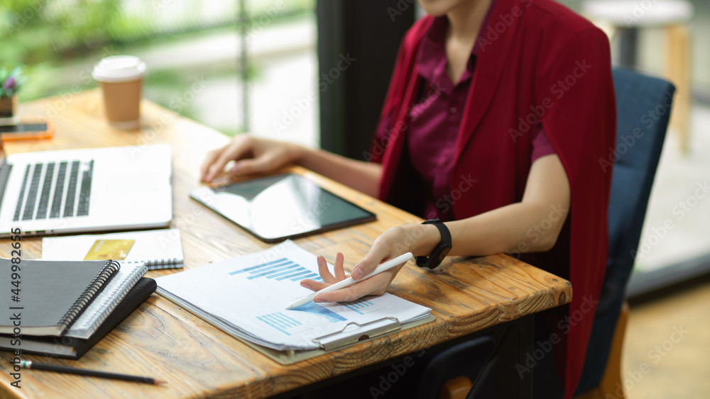 Elegant business analyst looking, working on business financial report Elegant business analyst looking, working on business financial report