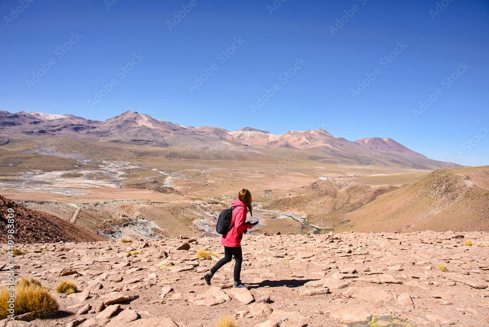 Hiking along the Rio Blanco thermal river near El Tatio Geyser, San Pedro de Atacama, Chile