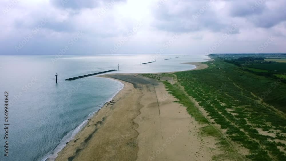 Aerial pull back shot flying backwards over an empty beach on the English coast Aerial pull back shot flying backwards over an empty beach on the English coast
