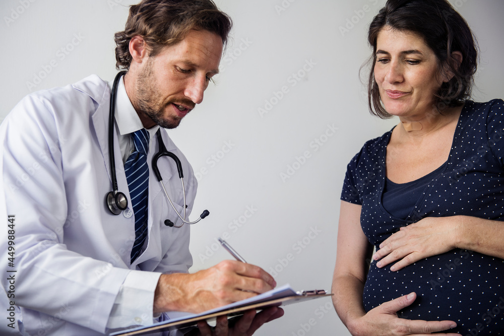 Pregnant woman having fetal monitoring by doctor Pregnant woman having fetal monitoring by doctor