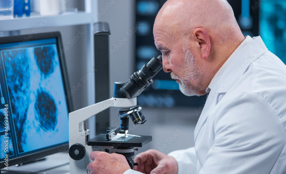 Professor works in a modern scientific laboratory using equipment and computer technologies. The scientist does research and develops new vaccines. Science and healthcare concept. Professor works in a modern scientific laboratory using equipment and computer technologies. The scientist does research and develops new vaccines. Science and healthcare concept.
