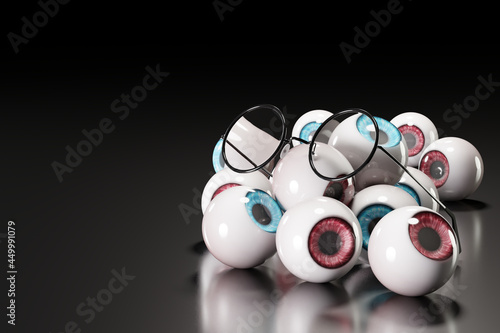 Round-shaped glasses were placed on several blue and brown eyeballs on a black floor and a dark background. The concept of eye problems and eye business concept. 3D illustration rendering.