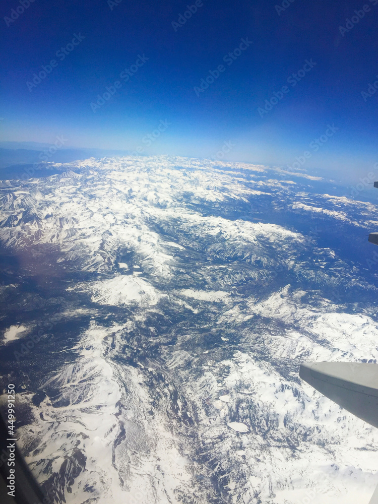 Mountain range aerial view from airplane window Mountain range aerial view from airplane window