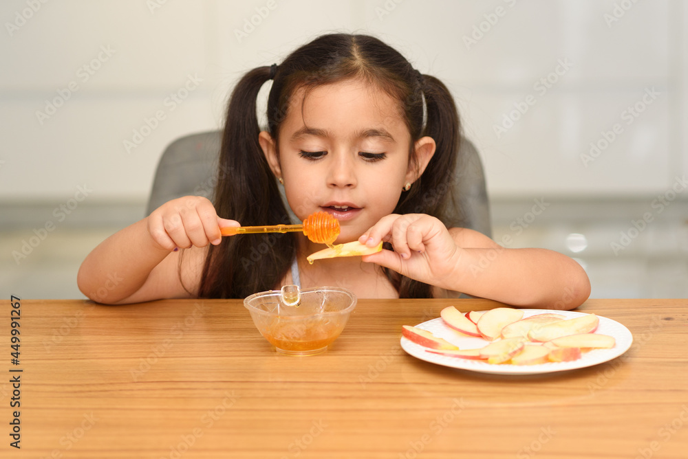 Little Girl Eating Apple With Honey. Healthy Eating For Children. Little Girl Eating Apple With Honey. Healthy Eating For Children.