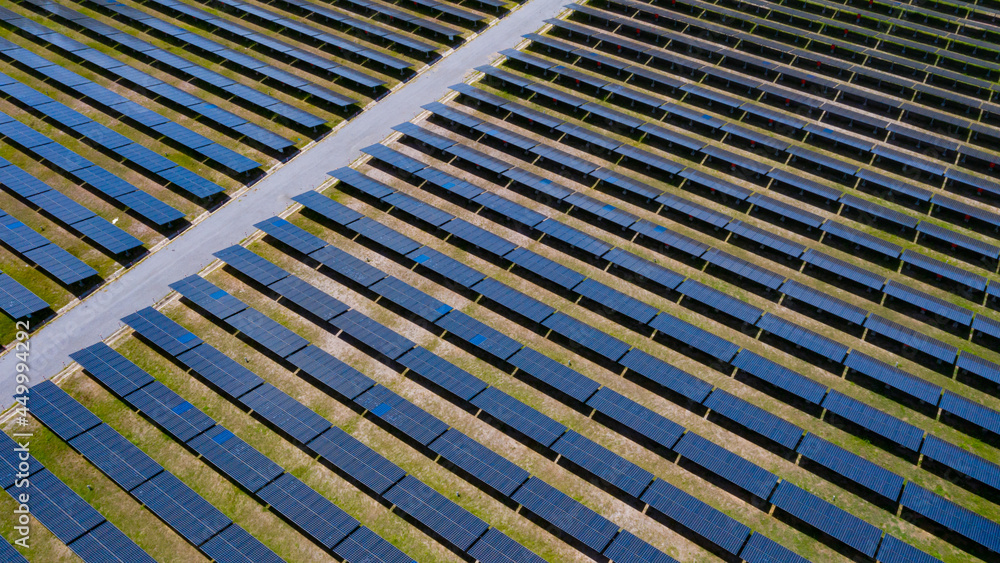 Aerial view above of solar panels in solar cell field to create the clean electric power industrial from nature. Drone shot. Aerial view above of solar panels in solar cell field to create the clean electric power industrial from nature. Drone shot.