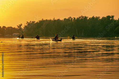 Canvas Print Sea kayakers paddle into the setting sun  on Long Pond on the Toronto Islands on a summer evening