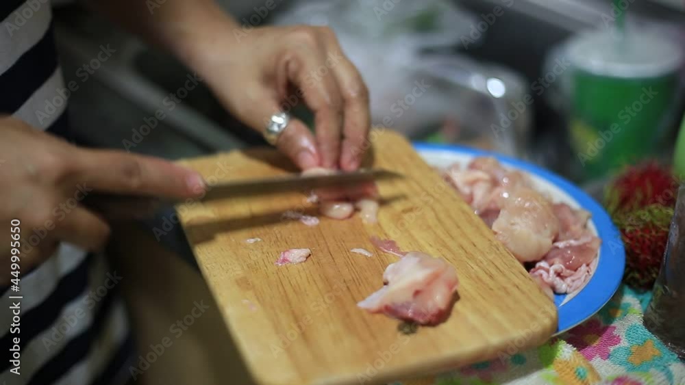 Blurred video background of chopping chicken or pork with a knife while cooking at home. Blurred video background of chopping chicken or pork with a knife while cooking at home.