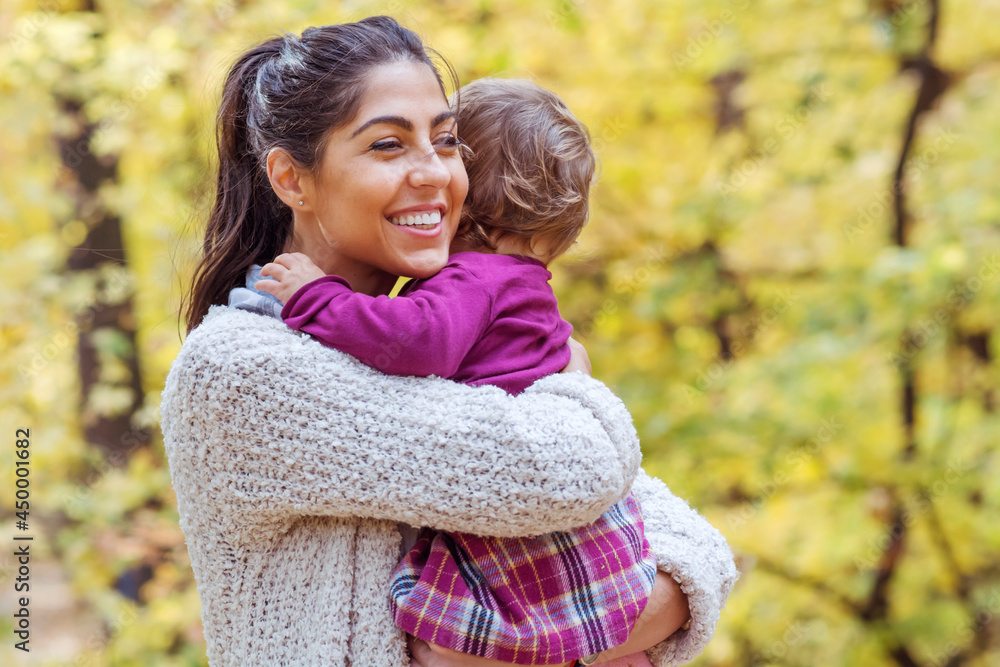 Happy Woman Hugging Little Girl Kid in the Autumn Yellow Forest. Happy Woman Hugging Little Girl Kid in the Autumn Yellow Forest.