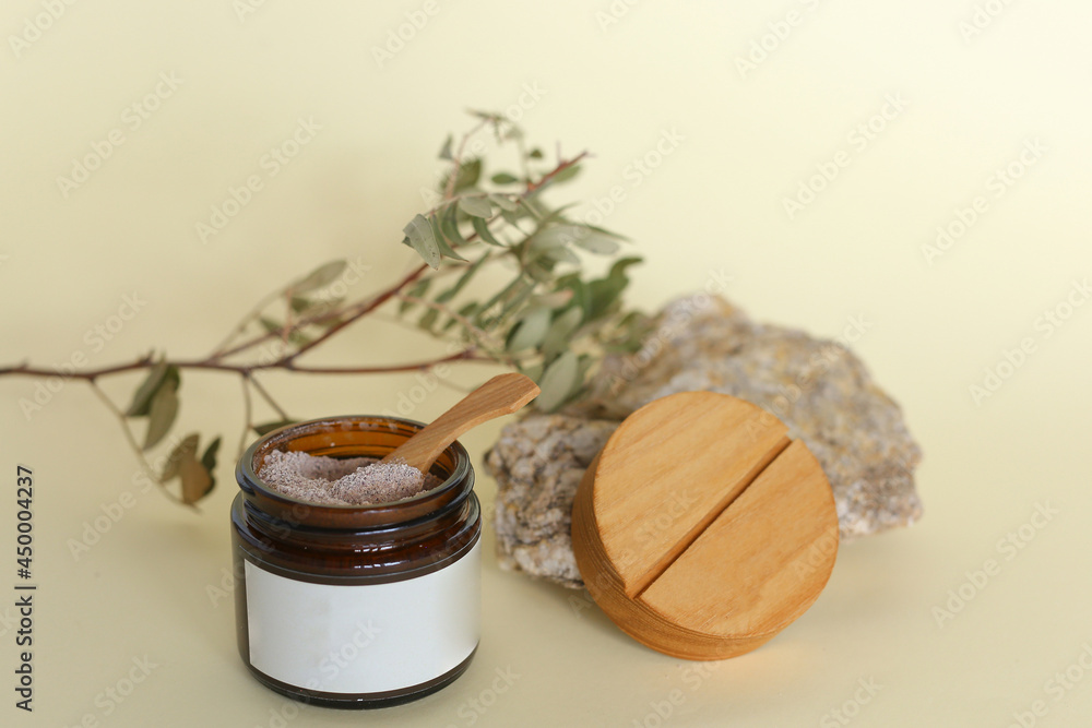 Body scrub of ground coffee, sugar and coconut oil in glass jar on table, homemade cosmetic for peeling and spa care Body scrub of ground coffee, sugar and coconut oil in glass jar on table, homemade cosmetic for peeling and spa care