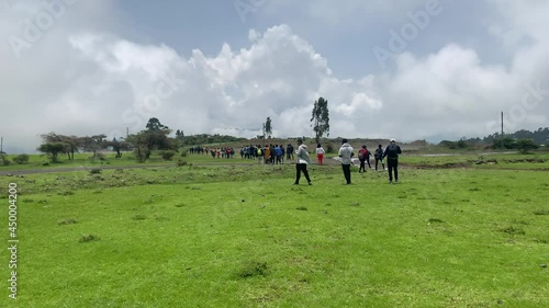 Group hikers is going to waterfall area in Debre Libanos, Debre Birhan, on very green field and close to the clouds. photo