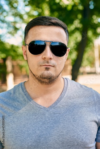 Close-up portrait of a young caucasian man in sunglasses