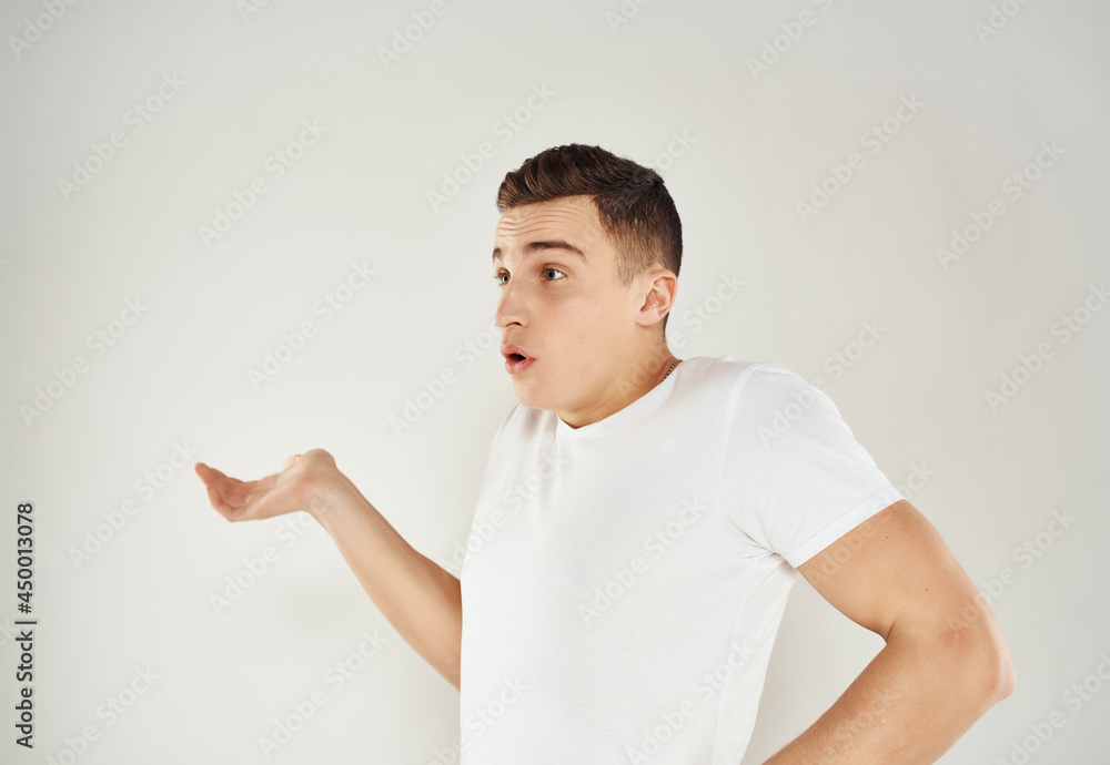 surprised man in white t-shirt throws up his hands emotions light background surprised man in white t-shirt throws up his hands emotions light background