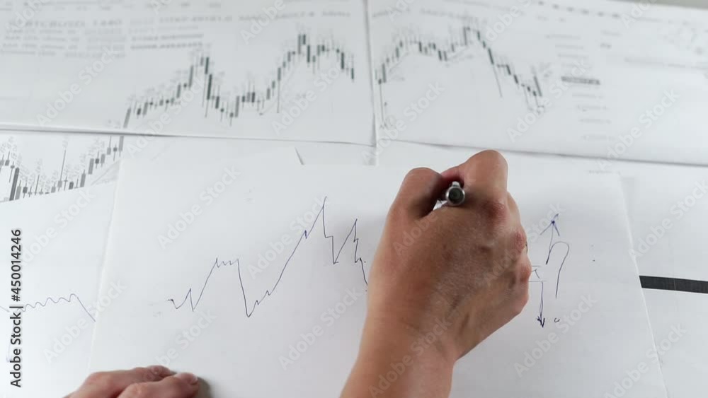 Bitcoin Stock Chart Analysis: A broker, trader or investor is analyzing a cryptocurrency stock chart. Bitcoin Stock Chart Analysis: A broker, trader or investor is analyzing a cryptocurrency stock chart.