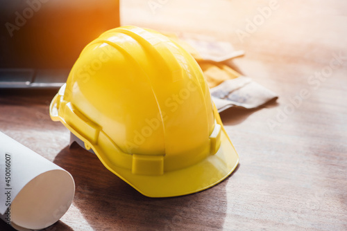 Yellow hard safety helmet hat for safety project of workman as engineer on together joining concept at construction site background.
