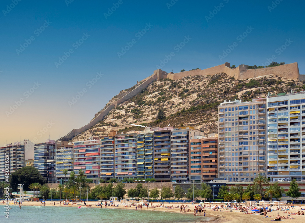 Modern residential buildings and the castle of Alicante at the forefront of the beach. Costa Blanca, Spain.