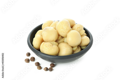 Bowl of marinated mushrooms isolated on white background