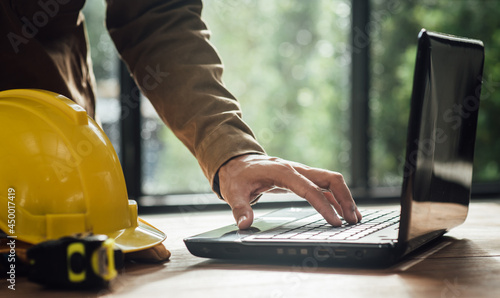 Engineer people architect meeting and pointing at drawings design project discussion working and engineering tools concept at construction site in the office.
