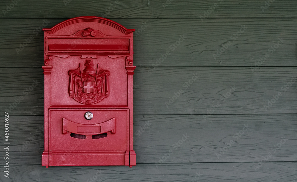 Old red postbox hung on a wooden wall Old red postbox hung on a wooden wall