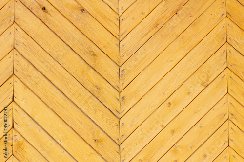 Wooden herringbone background.A fragment of an old wooden gate.