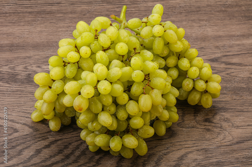 Green grape branch over background Green grape branch over background