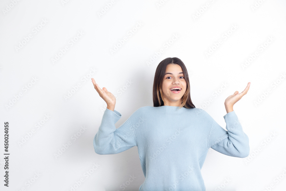 Portrait of an emotional joyful teenage girl. Joy. Happiness. Shopping. White background, space for text. Portrait of an emotional joyful teenage girl. Joy. Happiness. Shopping. White background, space for text.