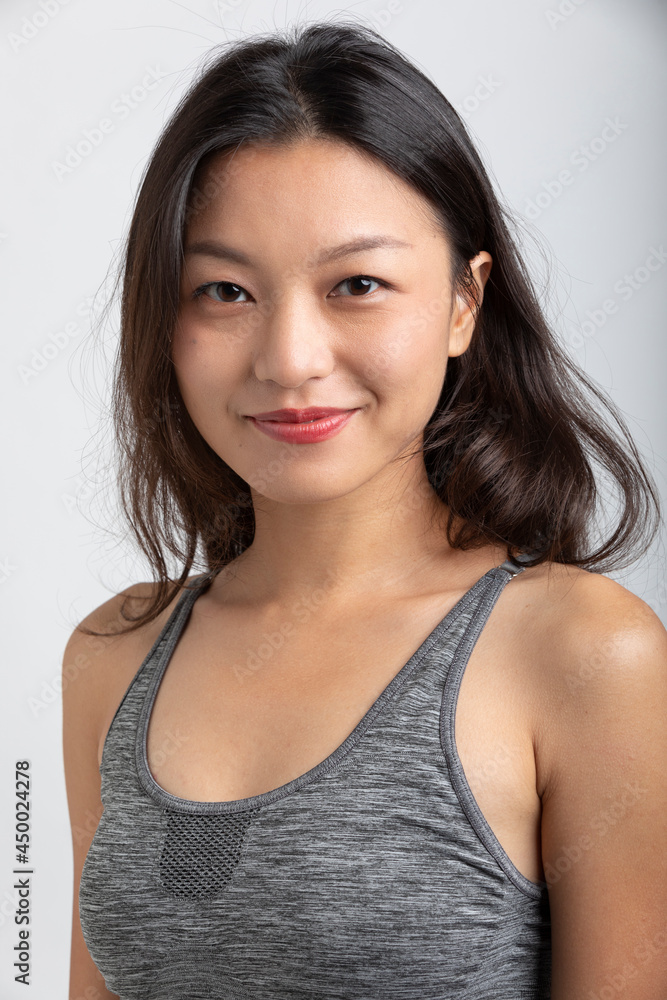 Portrait beautiful Asian girl with big smile and brown hair. Sportswear and lipstick Portrait beautiful Asian girl with big smile and brown hair. Sportswear and lipstick