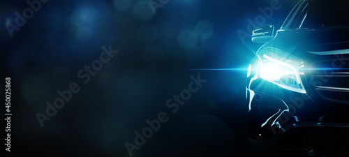 Front view of car concept. Modern sports car with lens flare on black bokeh background.