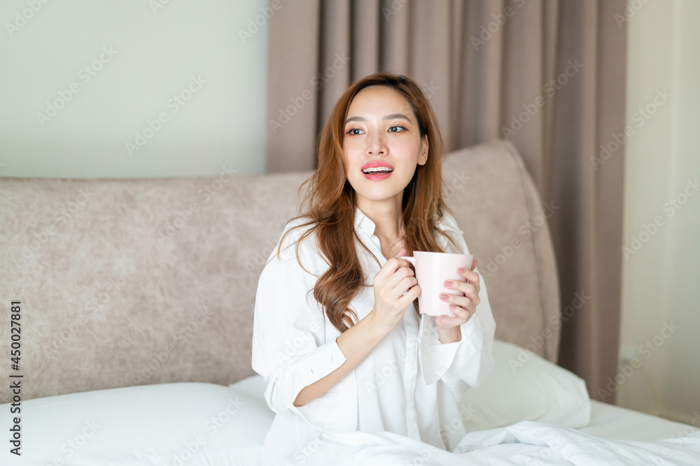 portrait beautiful woman wake up and holding coffee cup or mug on bed portrait beautiful woman wake up and holding coffee cup or mug on bed