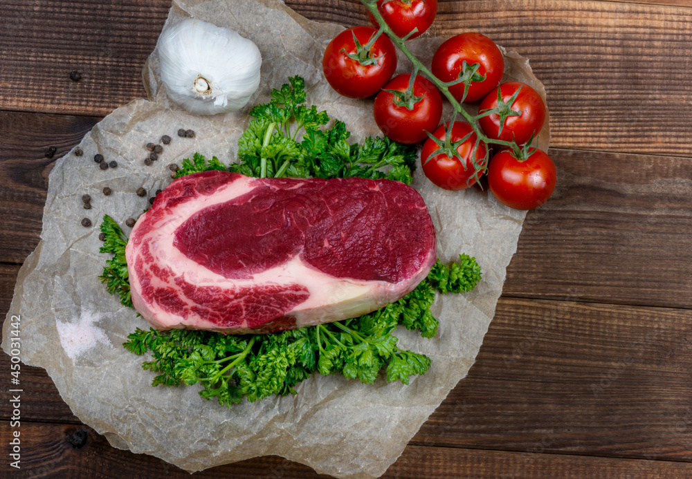Raw marbled ribeye steak and spices Raw marbled ribeye steak and spices