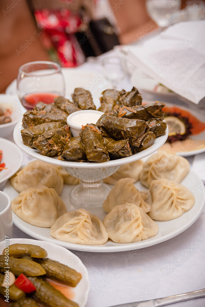 Hot dish: sarma and manti, served on the table Hot dish: sarma and manti, served on the table
