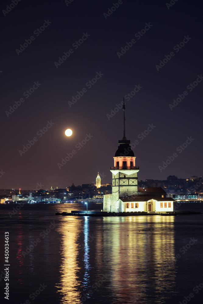 Maiden's Tower and Galata Tower at night with full moon. Maiden's Tower and Galata Tower at night with full moon.