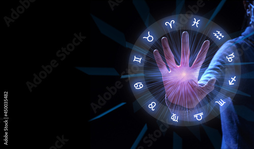 Zodiac signs inside of horoscope circle. Astrology with hand to stop.