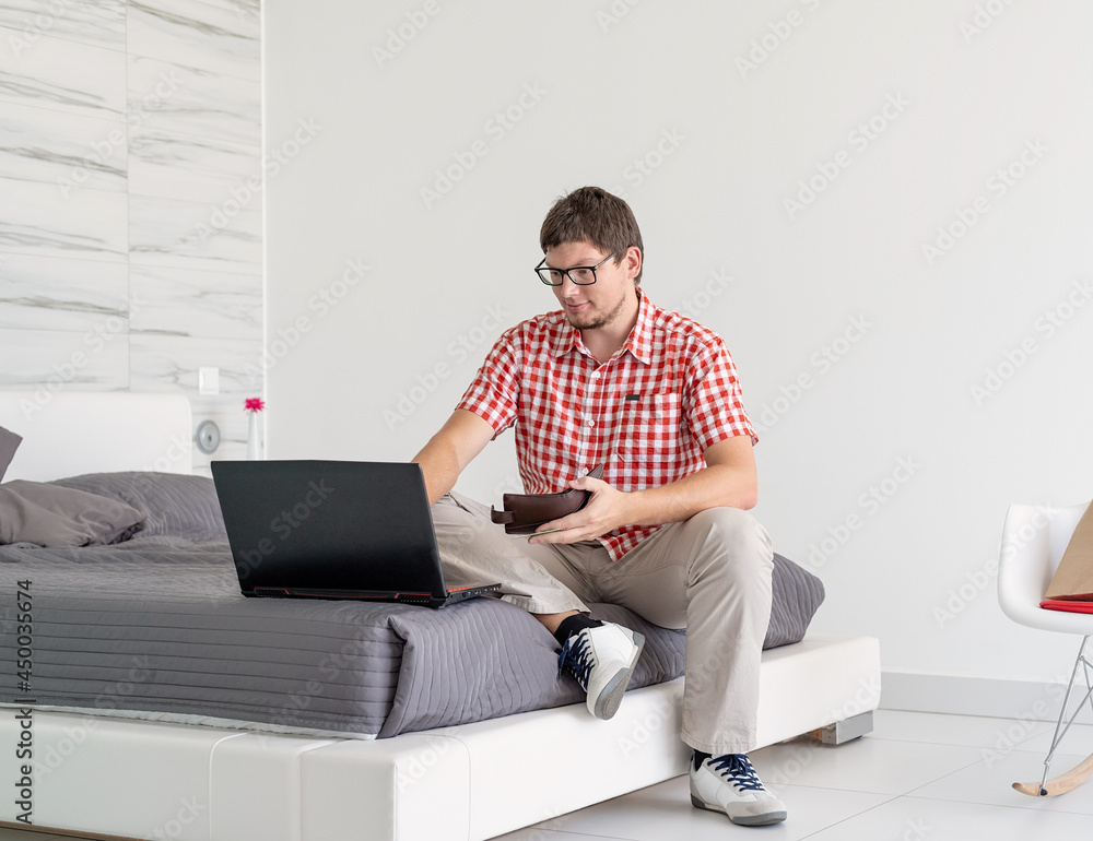Young man shopping on internet with laptop Young man shopping on internet with laptop
